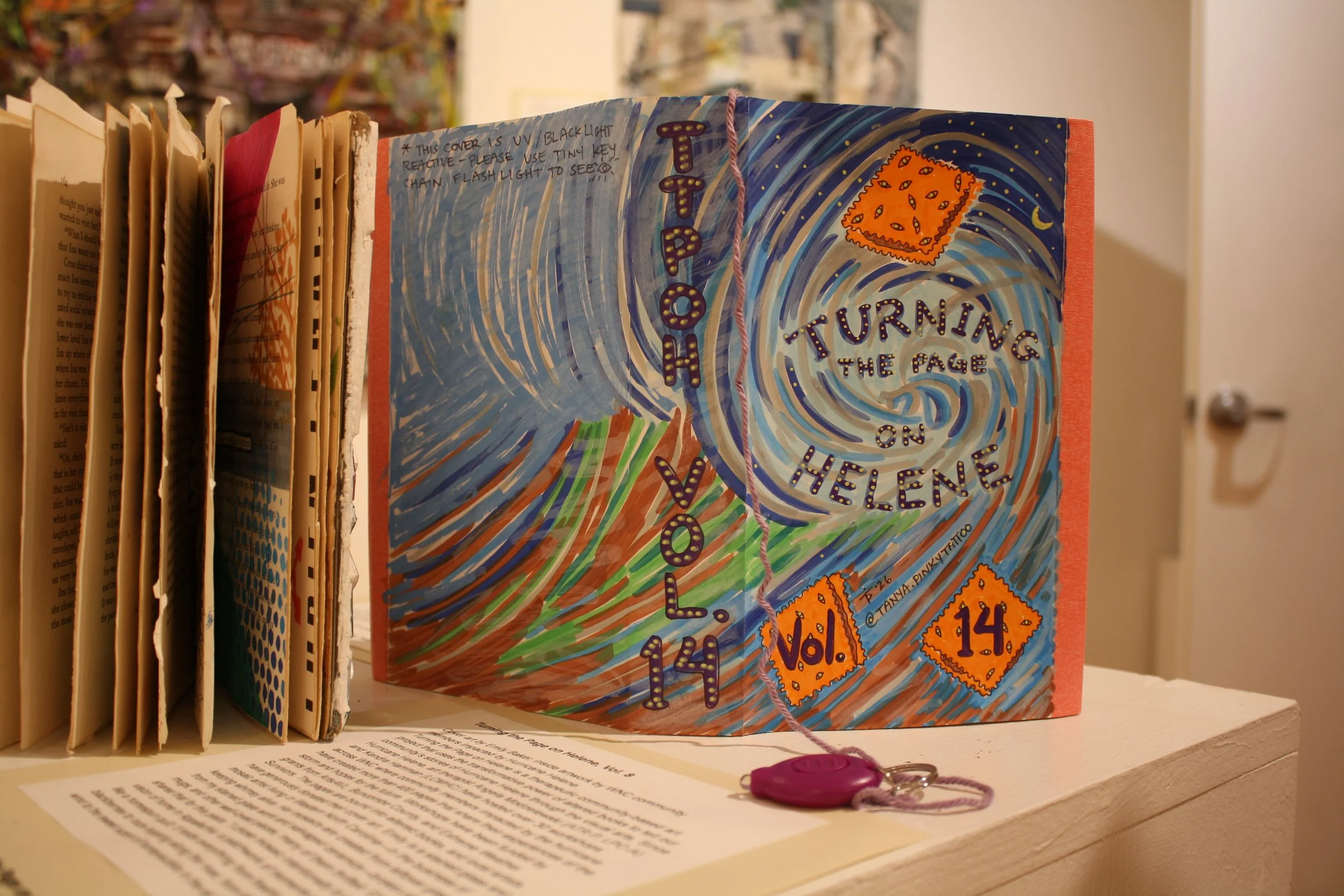  Tânya Pinky Pineda’s book cover design for Angela Modzelewski's community art project titled “Turning the Page on Helene vol. 14” displayed at the Contemplating Helene opening reception at the Black Mountain Center for the Arts, on Sep. 4, 2026, Bla