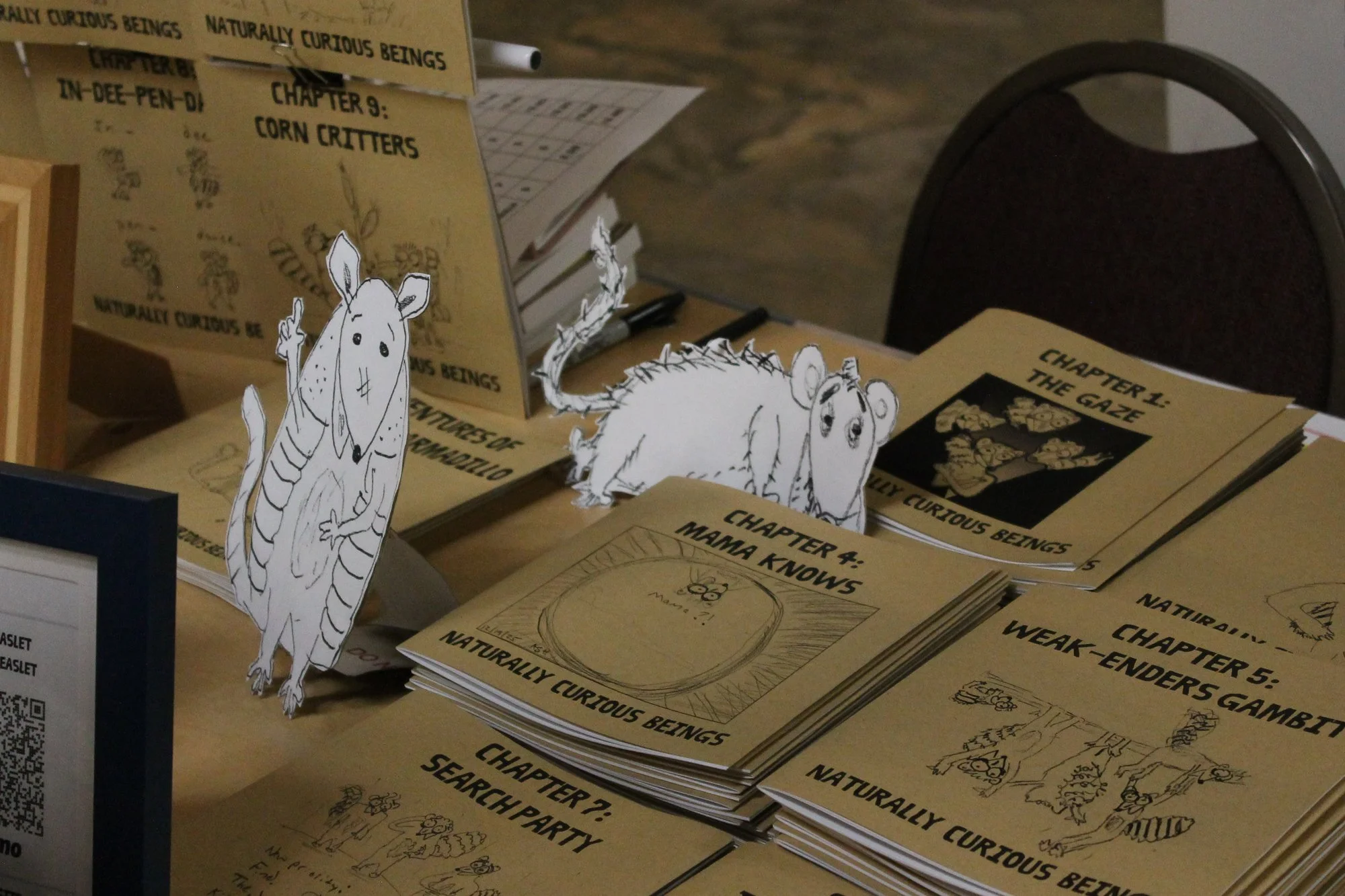    Naturally Curious Beings  ’ table, with titles like “Weak-Enders Gambit” and “Corn Critters”. Asheville, N.C.,Saturday Sept. 26, 2026. (Echo News/Wyatt Layton) 
