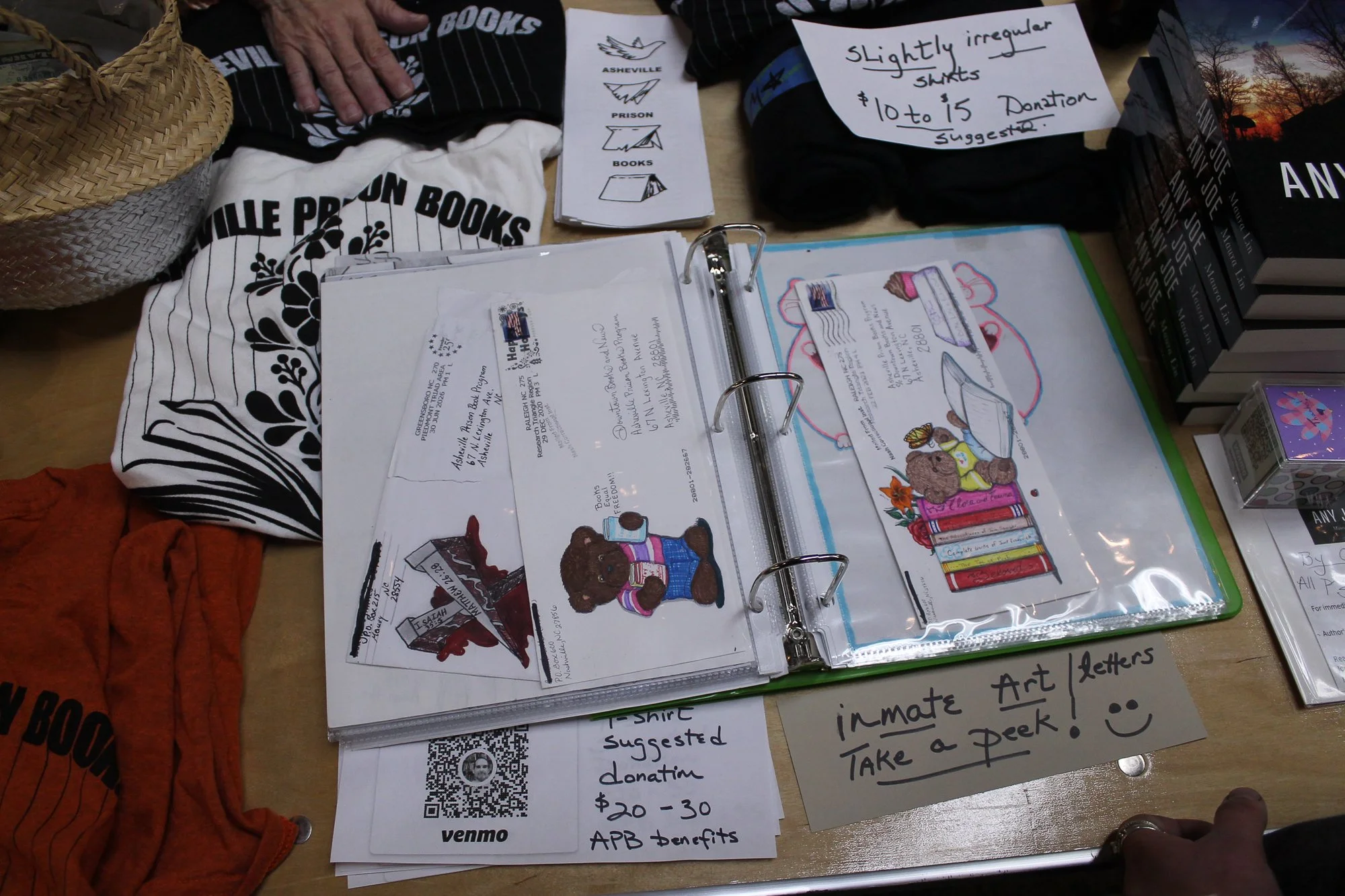  Asheville Prison Books showcases a binder of art and letters from inmates in North and South Carolina Prisons at Asheville Zine Fest in Asheville, N.C., Saturday Sept. 26, 2026. (Echo News/Wyatt Layton) 