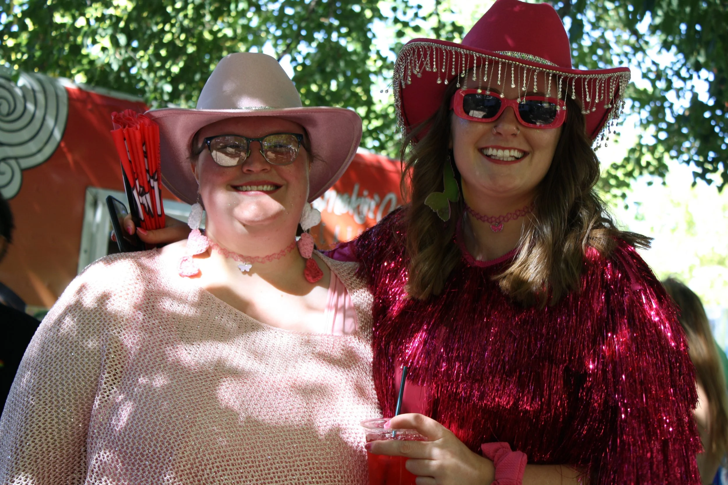  Two attendees pose for a photo wearing matching cowgirl hats at Blue Ridge Pride on Sep. 26, 2026 in Pack Square Park in Asheville, N.C. (Echo/Emma Taylor McCallum) 