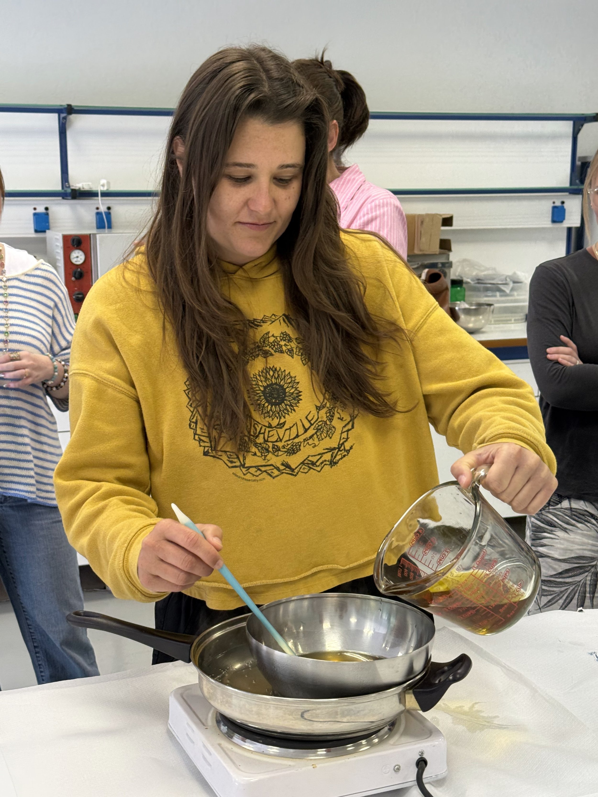  Taylor Knops pours olive into a pot during a workshop at Perrotis College in Thessaloniki, Central Macedonia, Greece on May 14, 2026 (courtesy of Jill Arnold) 