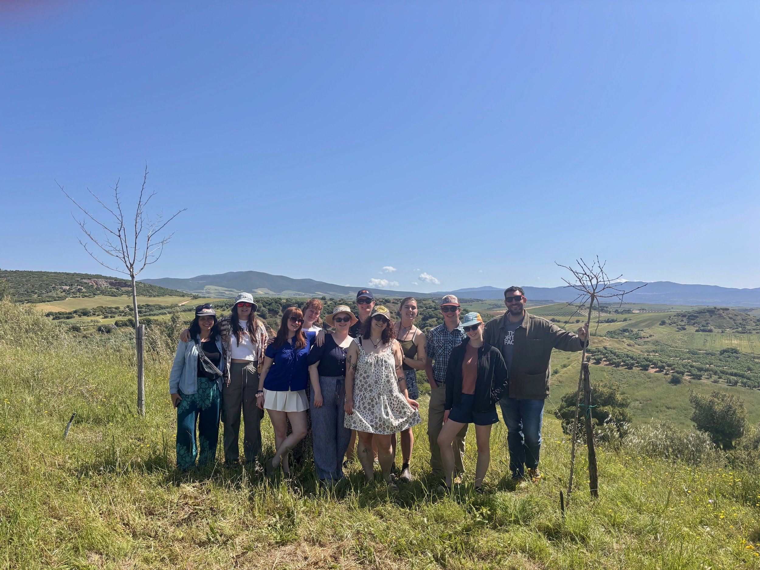  The spring 2026 Climate Change and Mediterranean Ecosystems class stand with an olive farmer from KLEA's Olive Grove on Halkidiki peninsula, Nea Tenedos, Central Macedonia⁩, Greece on May 16, 2026 (courtesy of Gregory Karampetian) 