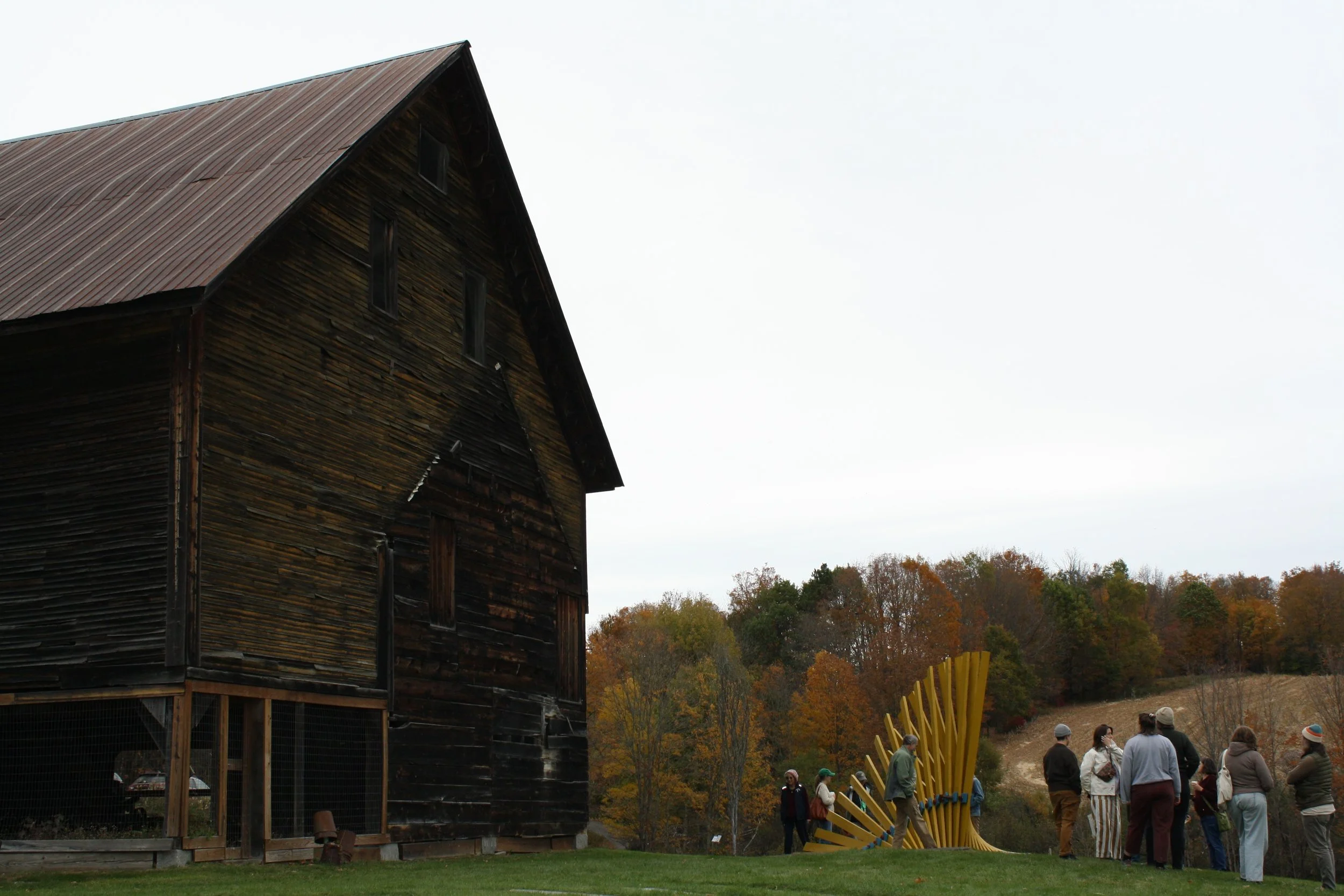  Community members gather around James Payne’s sculpture titled “Opposition” at Art at the Kent’s 2026 exhibition, Throughlines, Calais Vt. Oct. 11, 2026. (Echo/Emma Taylor McCallum) 