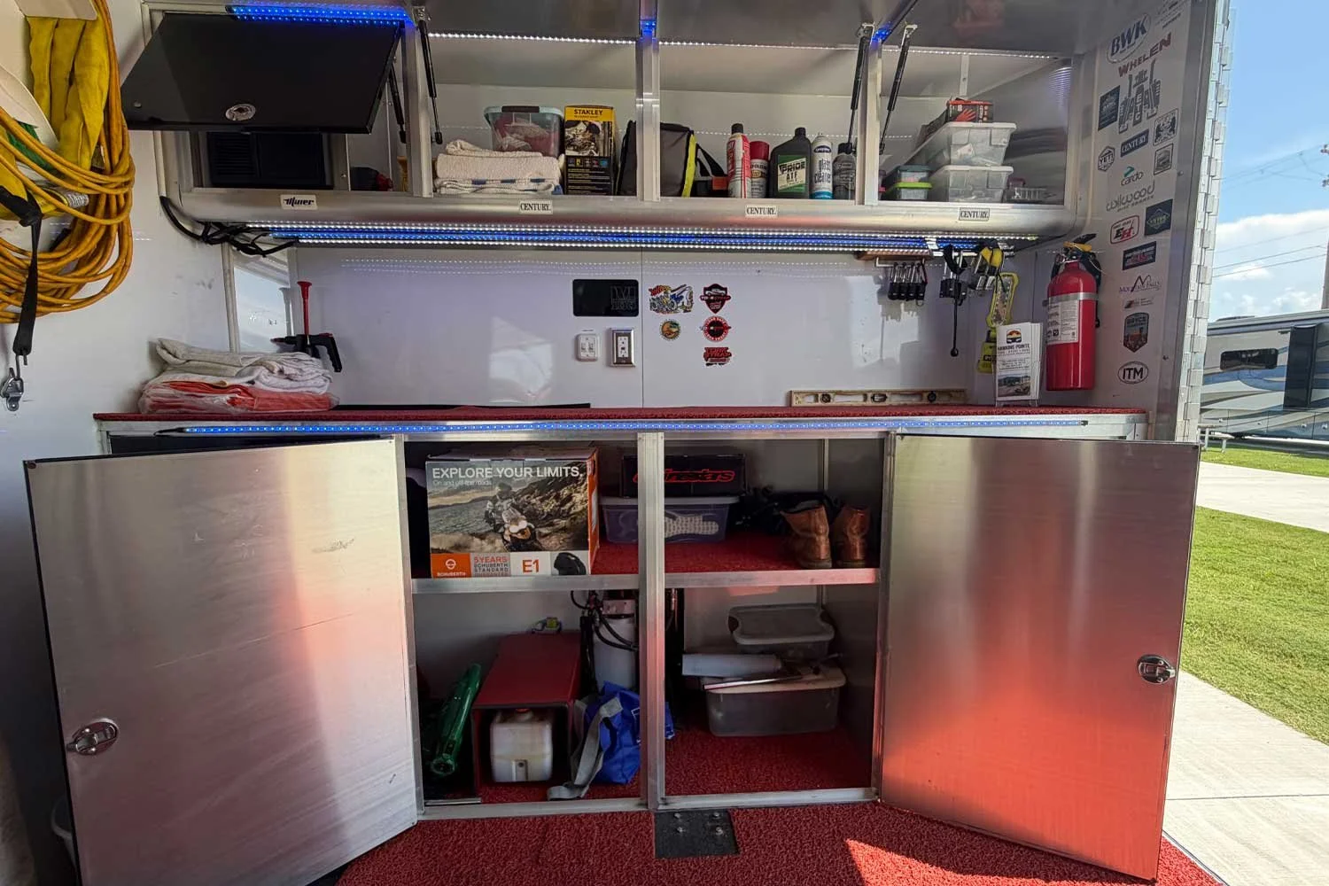 Open storage cabinets with gear and supplies