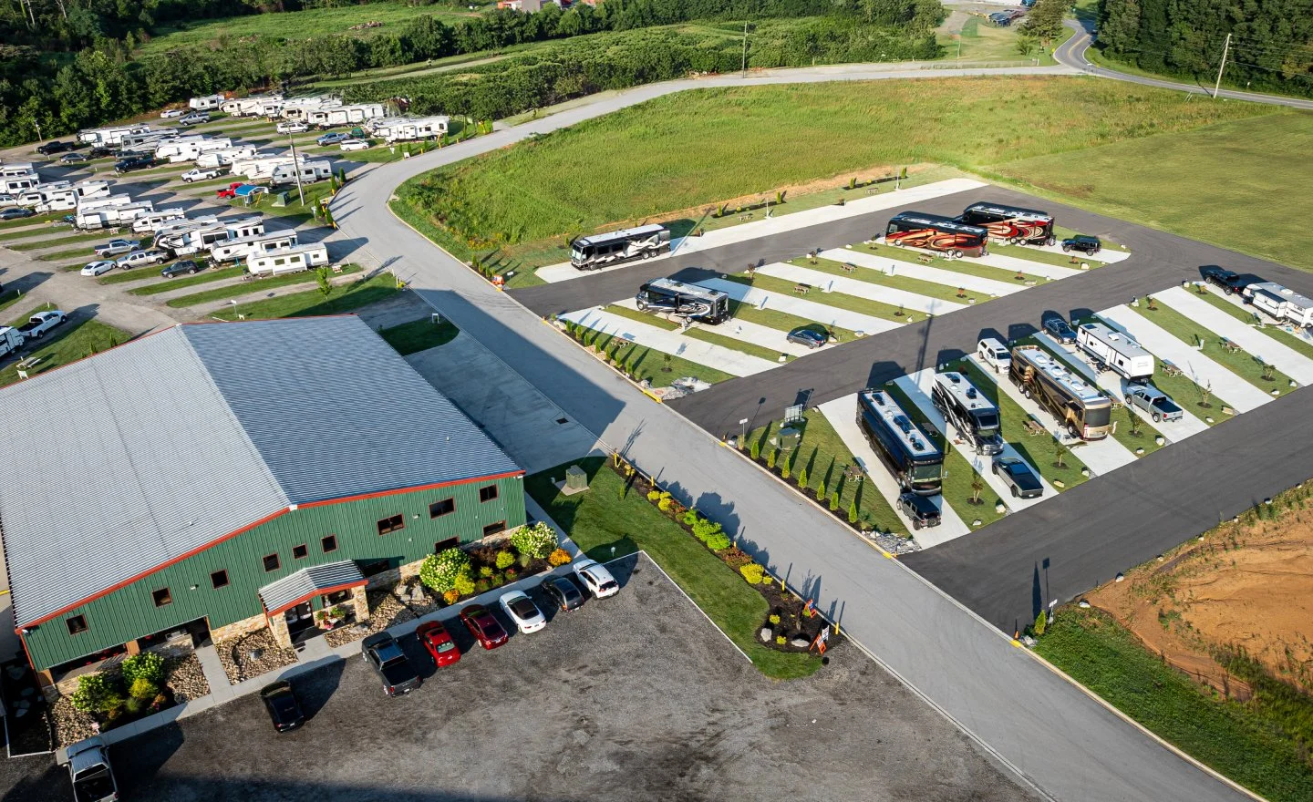 Aerial view of Hawkins Pointe RV park with multiple RVs, trailers, buses, and cars parked in designated spots.
