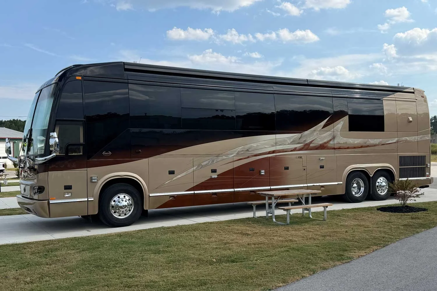 Driver-side view of the coach parked in executive lot.