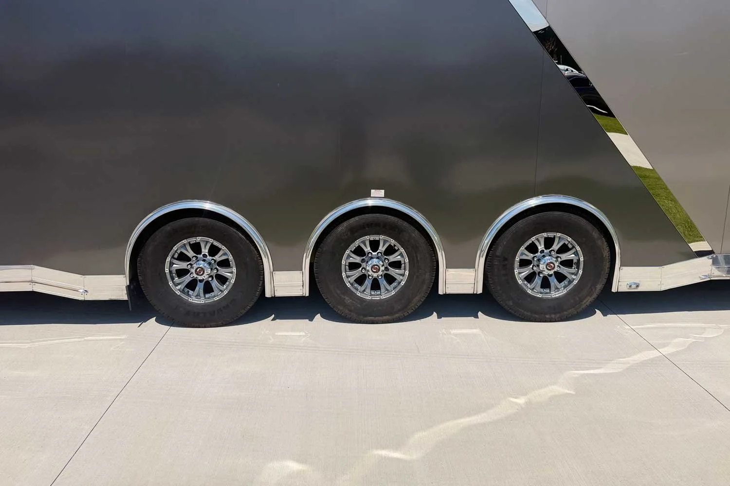 Close-up of the tri-axle wheels and fenders.