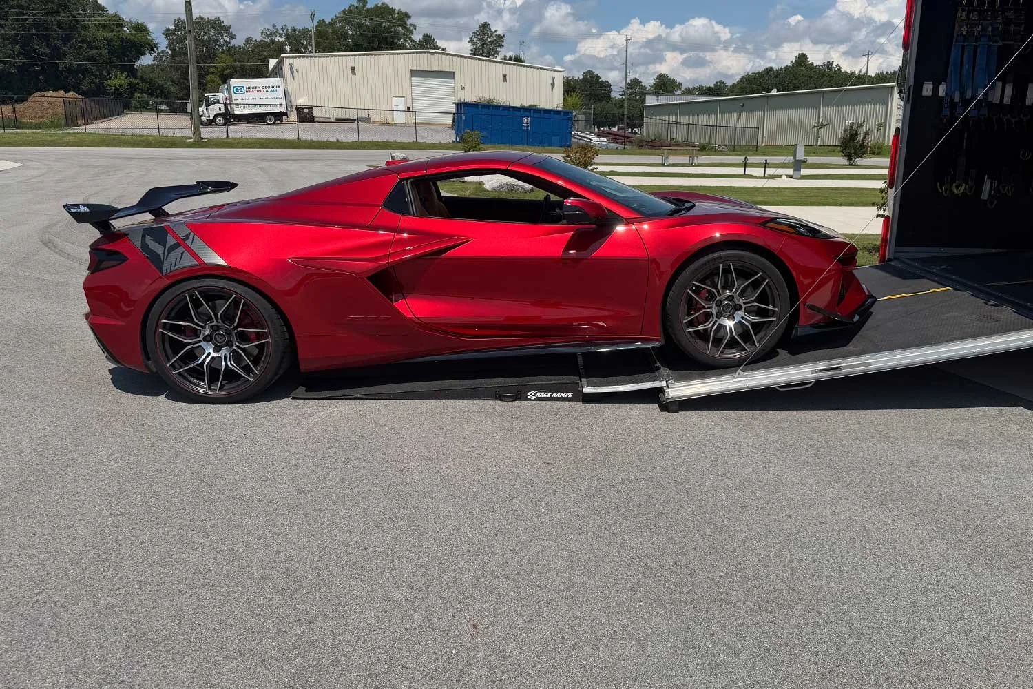 Red Corvette loading onto the trailer's lift ramp