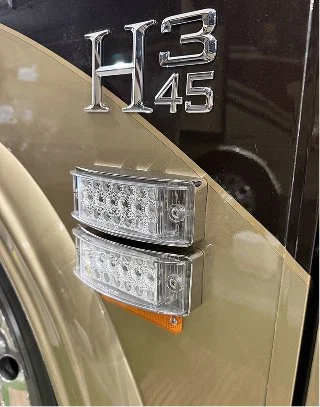 Dual clear-lens LED side marker lights installed on a Prevost H3-45 coach.