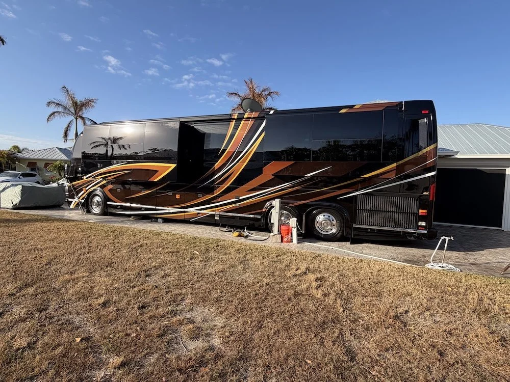 Side angle showing extended slides and high-gloss black paint.