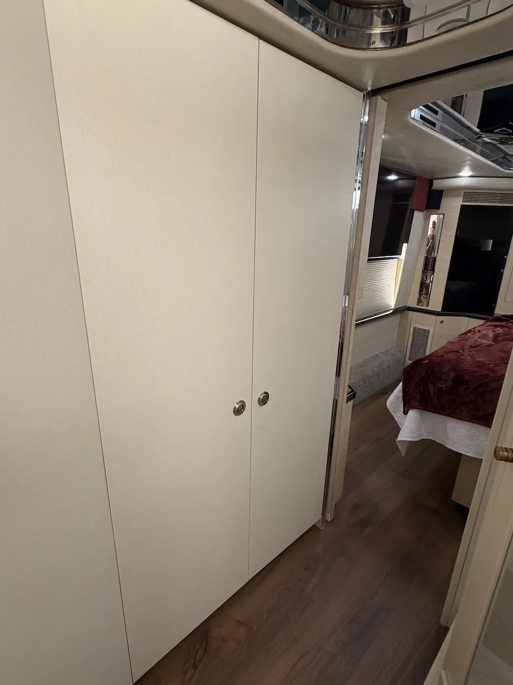 Hallway with closets leading to bedroom.