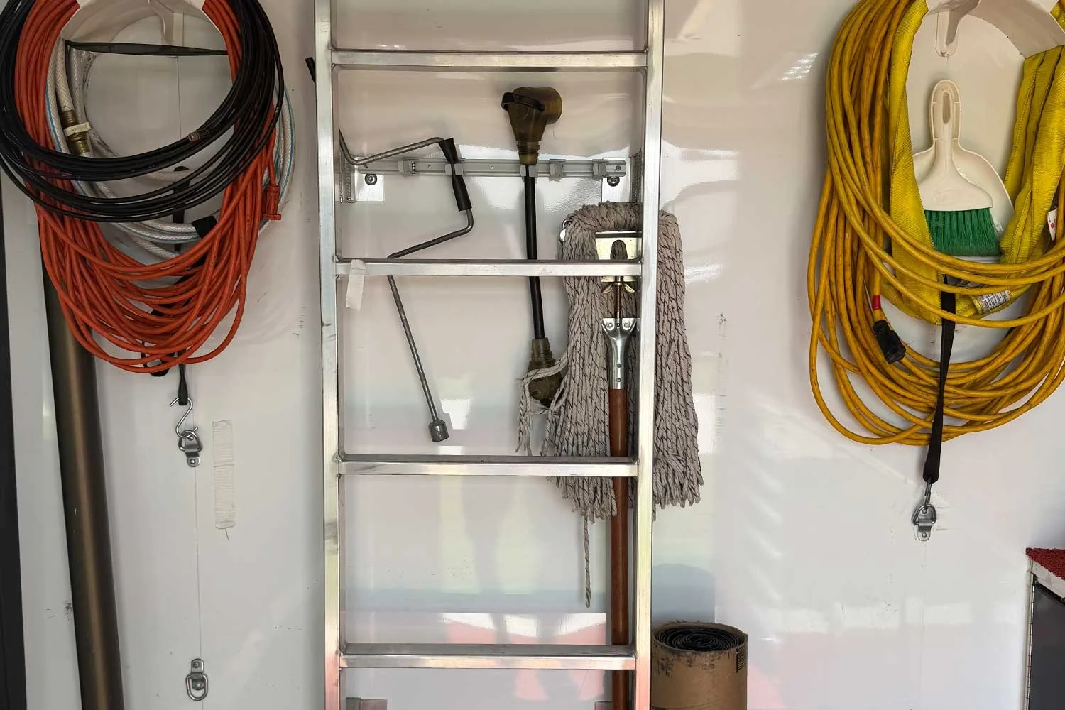 Ladder and cleaning tools mounted on the wall