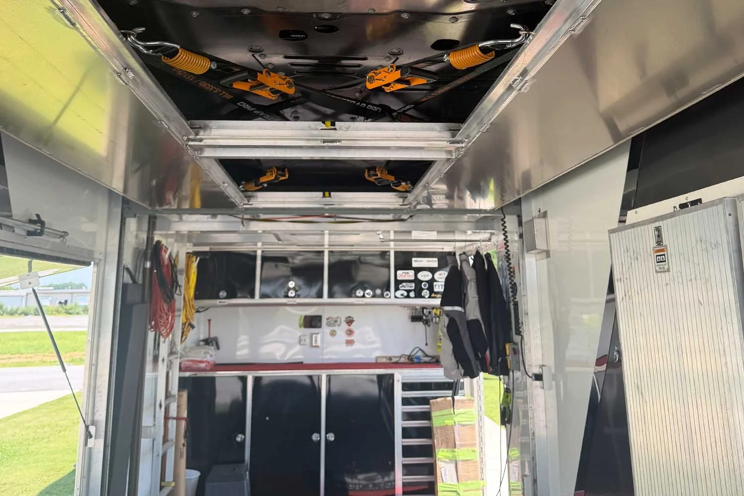 Interior view of overhead straps and storage cabinets
