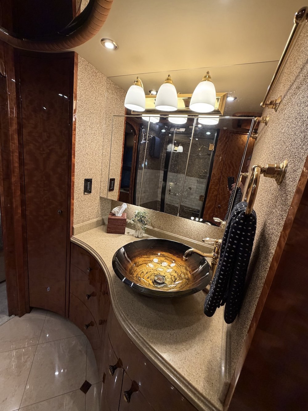 Interior of a luxurious RV bathroom with bowl sink.l