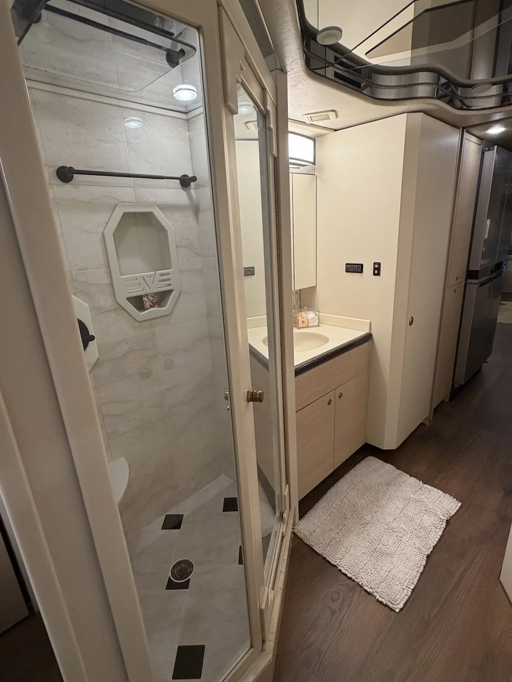 Bathroom with glass shower and vanity sink.