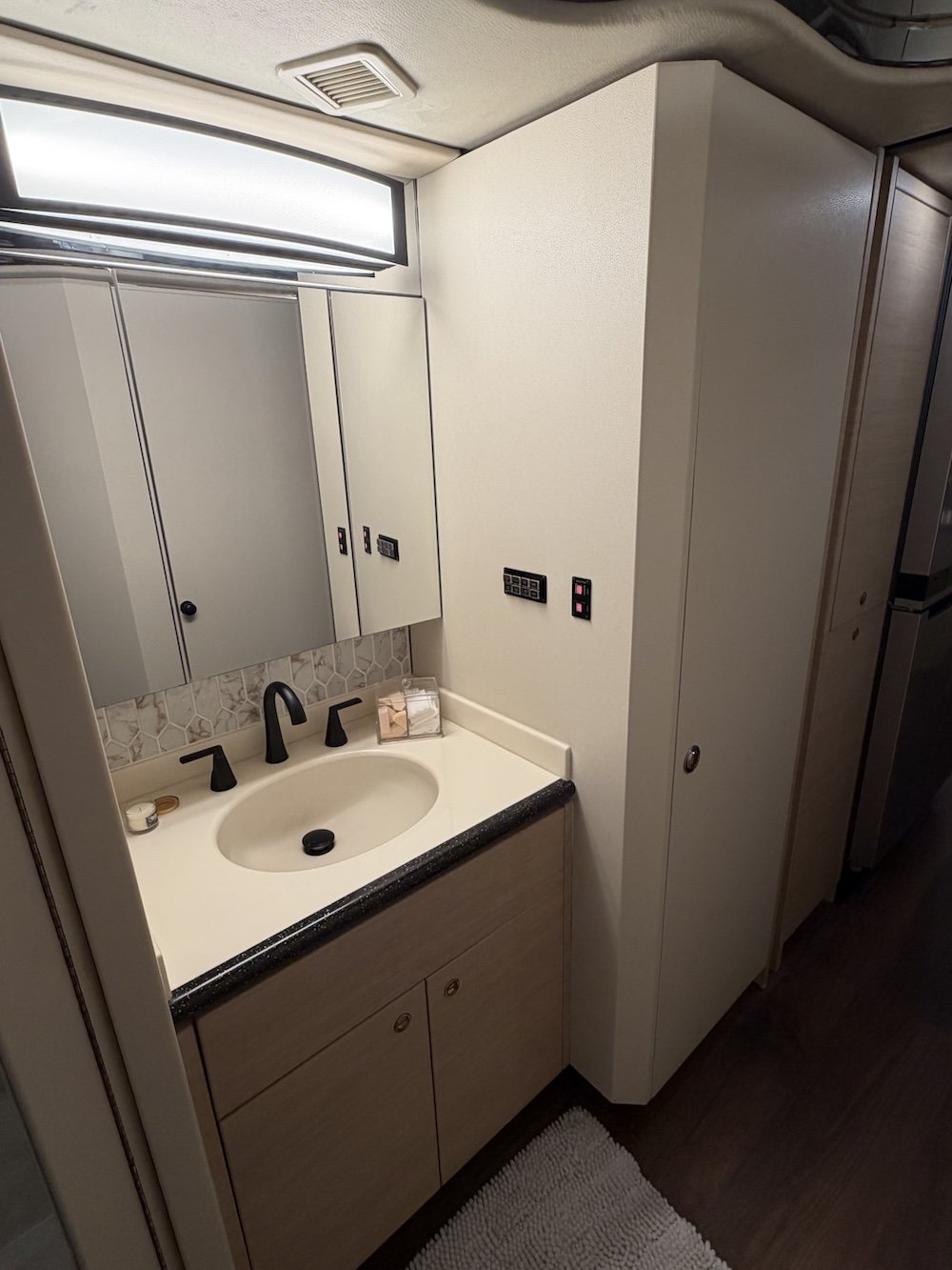 Bathroom vanity with sink and faucet.