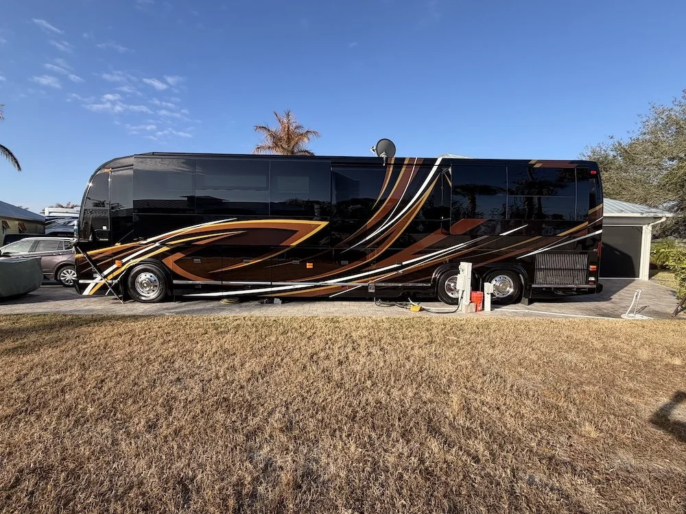 Side image of the 2016 Prevost Marathon 2016 with orange and red paint.