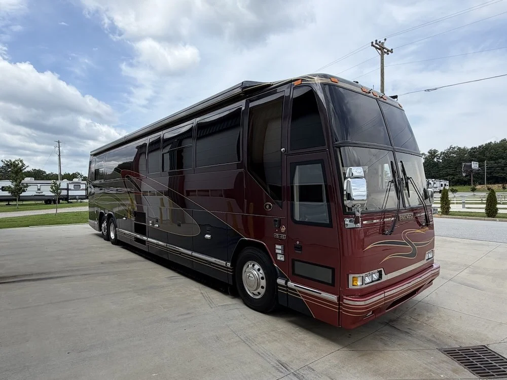 Front passenger-side view of the coach outdoors.