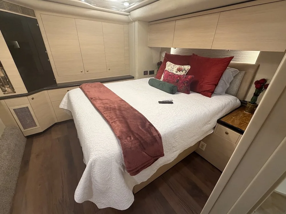 Master bedroom with bed, pillows, and cabinetry.