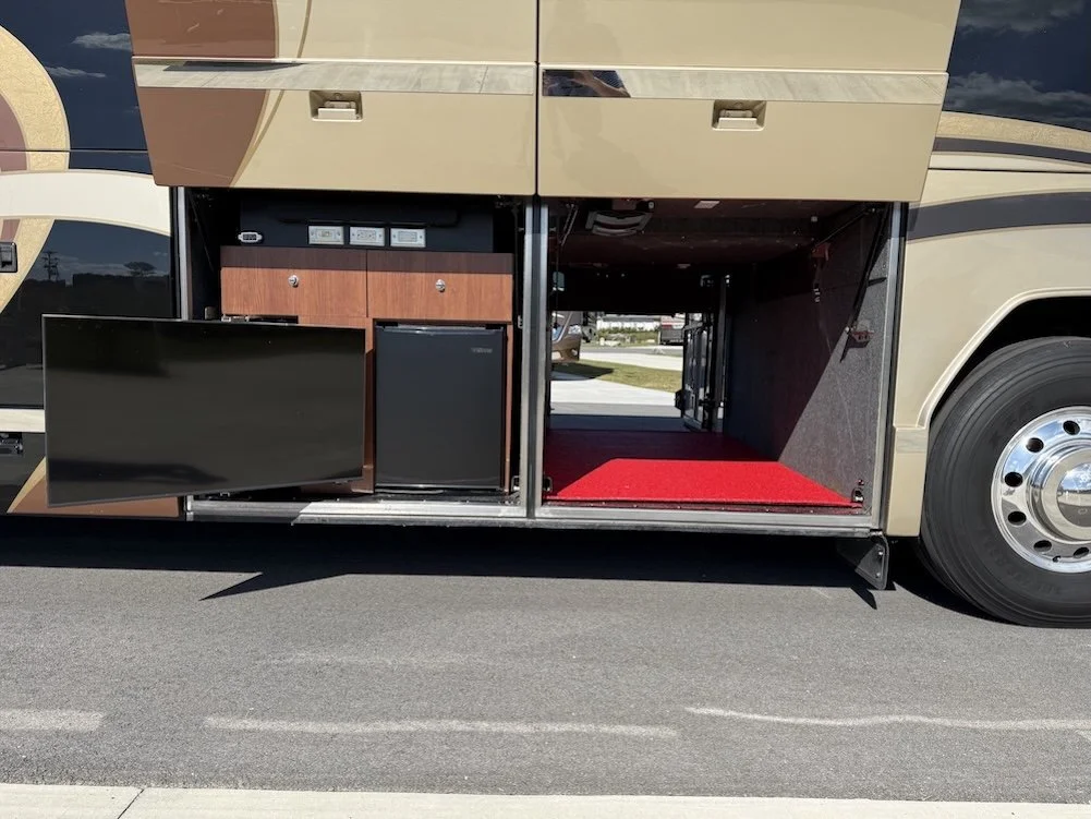 Outdoor entertainment bay with an integrated flat-screen TV and mini-fridge.