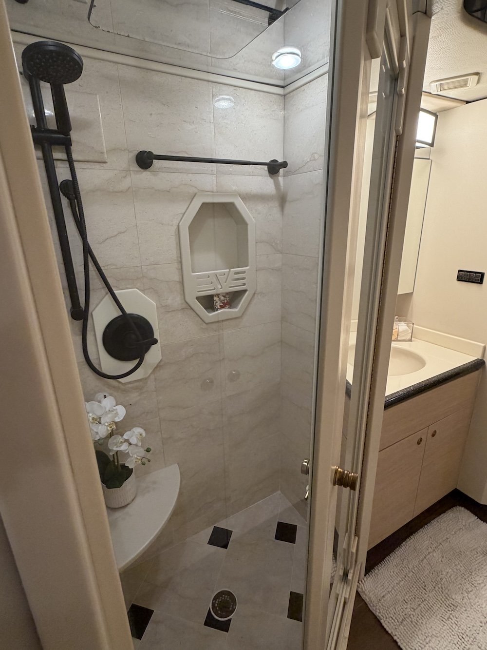 Walk-in shower with glass door.