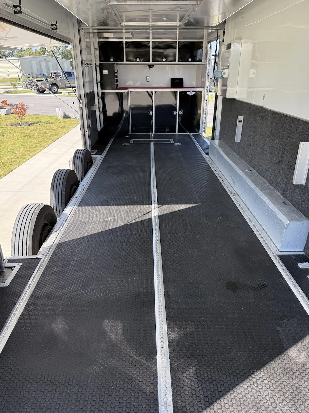 Transport trailer with storage cabinets and equipment inside.