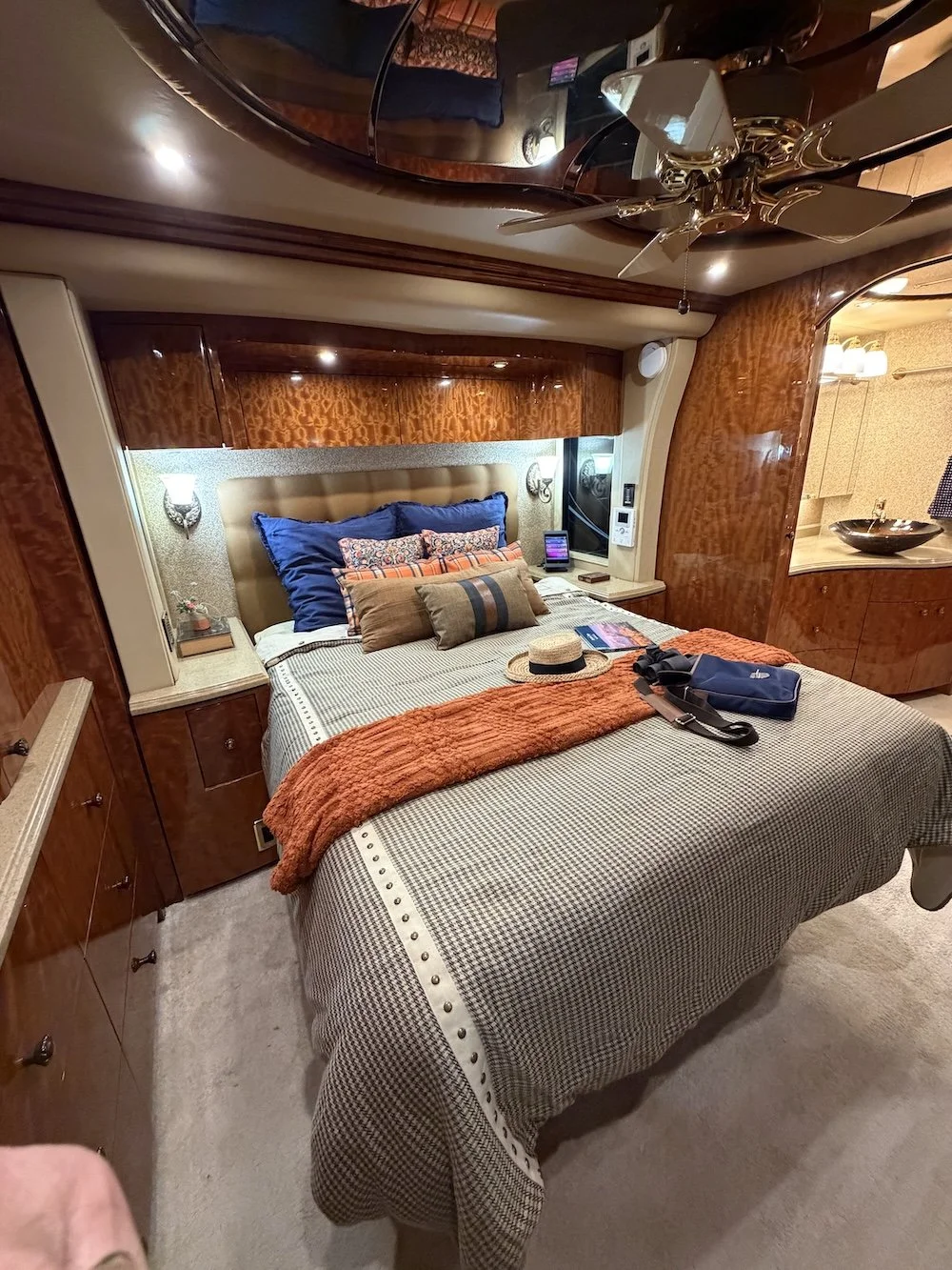 Interior of a modern luxury RV bedroom with overhead lighting.