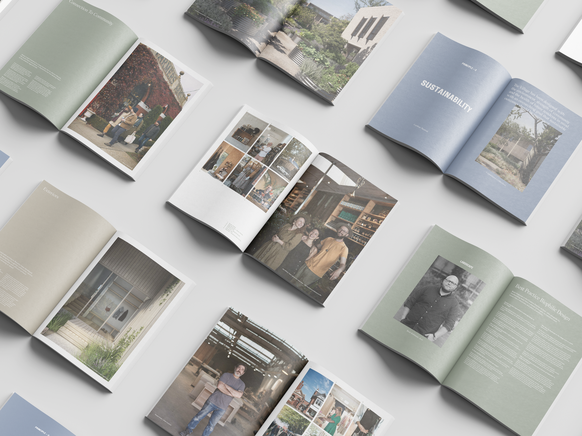 Multiple open books or magazines spread out on a white surface, showcasing various pages with text, images of architecture, people, and design elements.