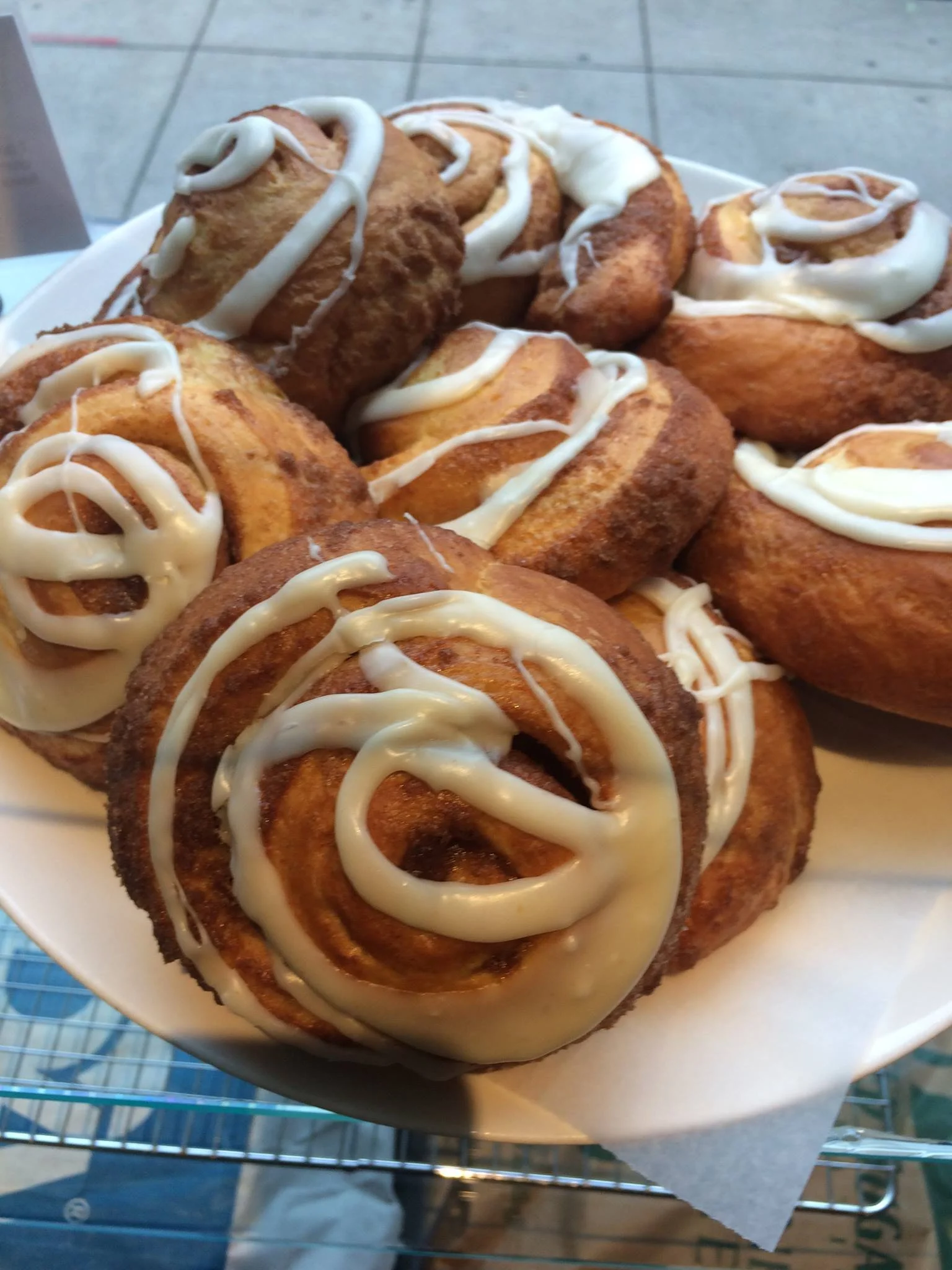 Plate of cinnamon rolls with white icing