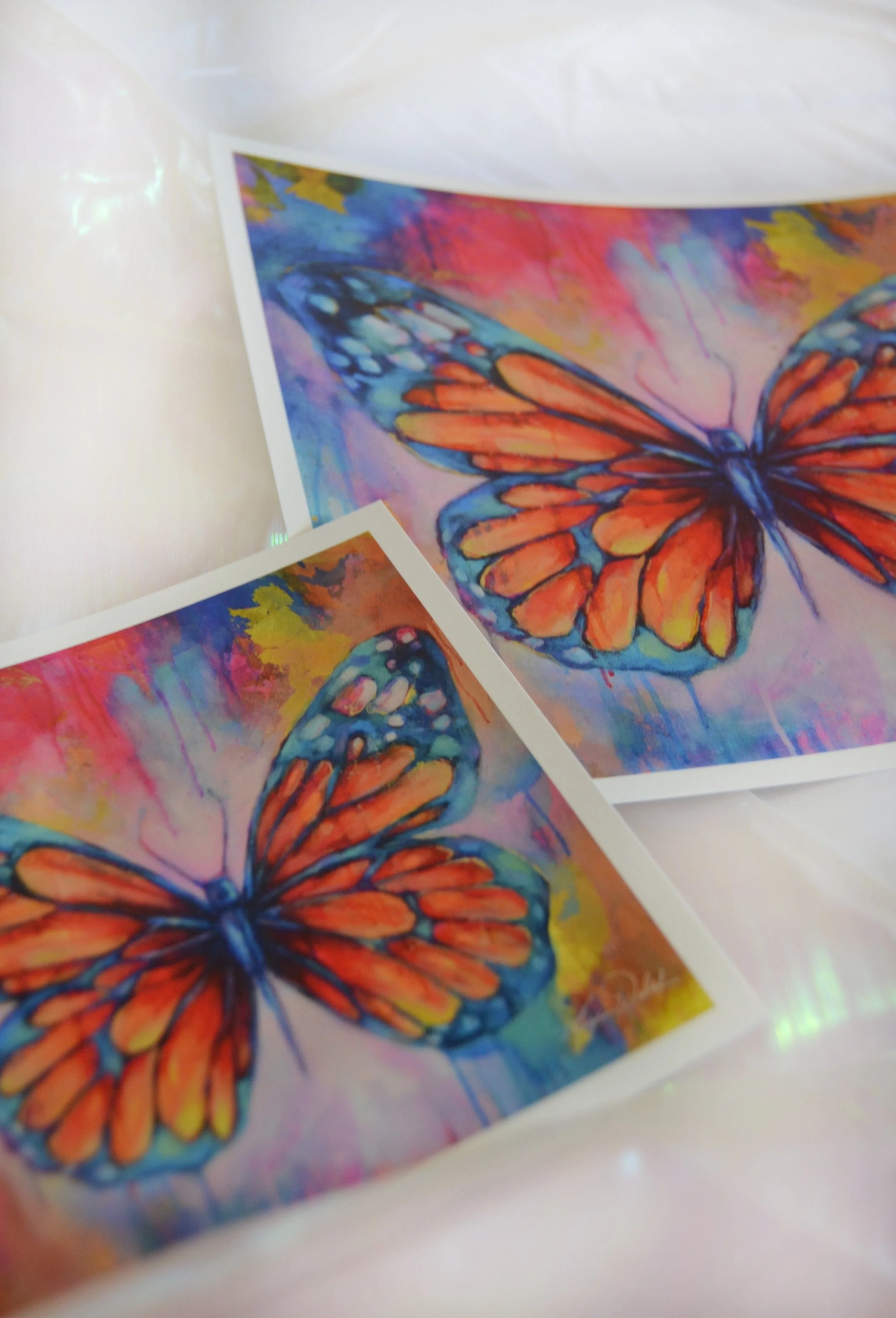 Colorful watercolor painting of an orange and blue butterfly