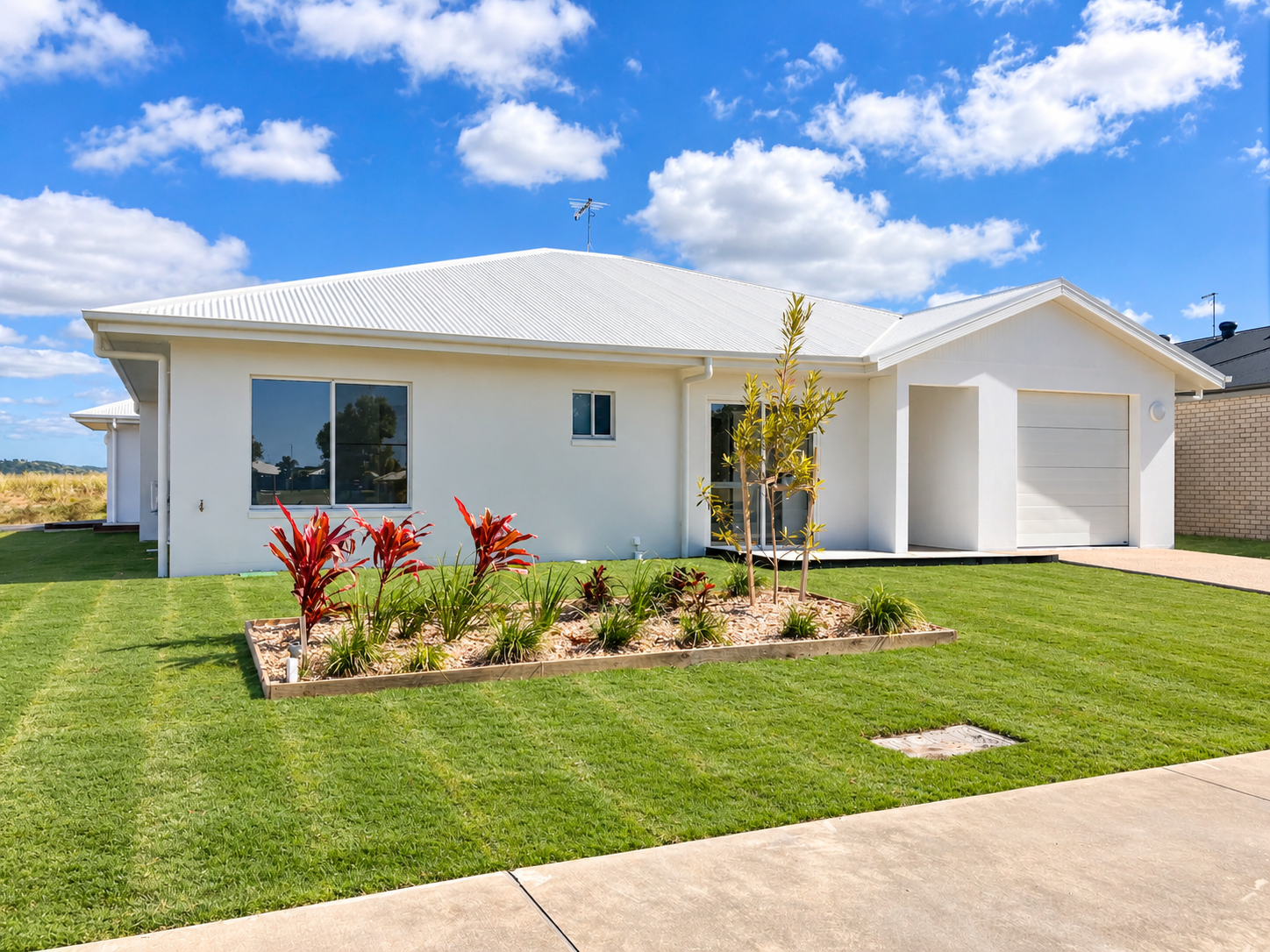 Modern Suburban Home with Landscaped Yard.png