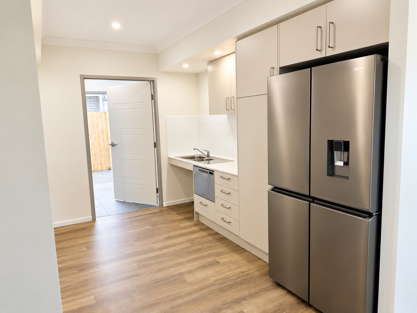 Modern Galley Kitchen with Open Courtyard Door.png