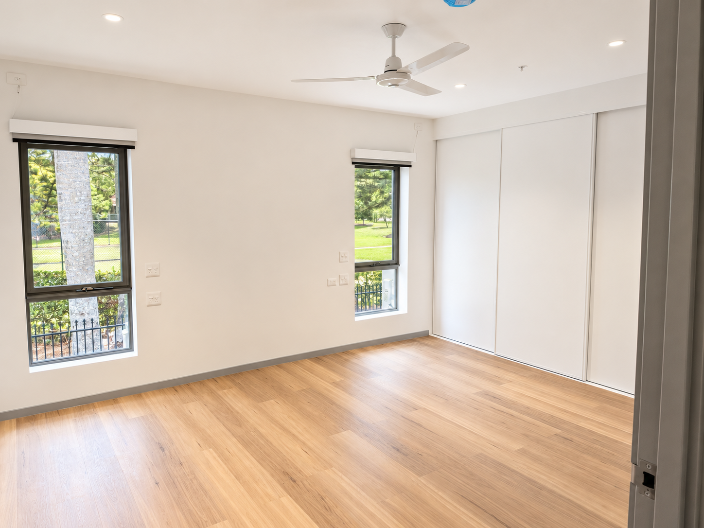 Bright Minimalist Bedroom with Garden Views.png