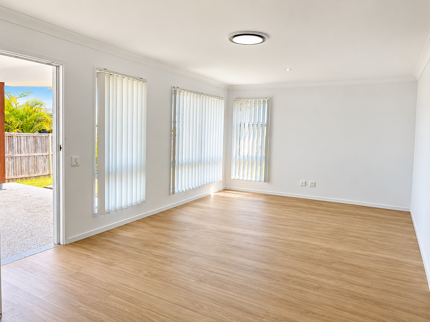 Bright Empty Living Room with Patio View.png