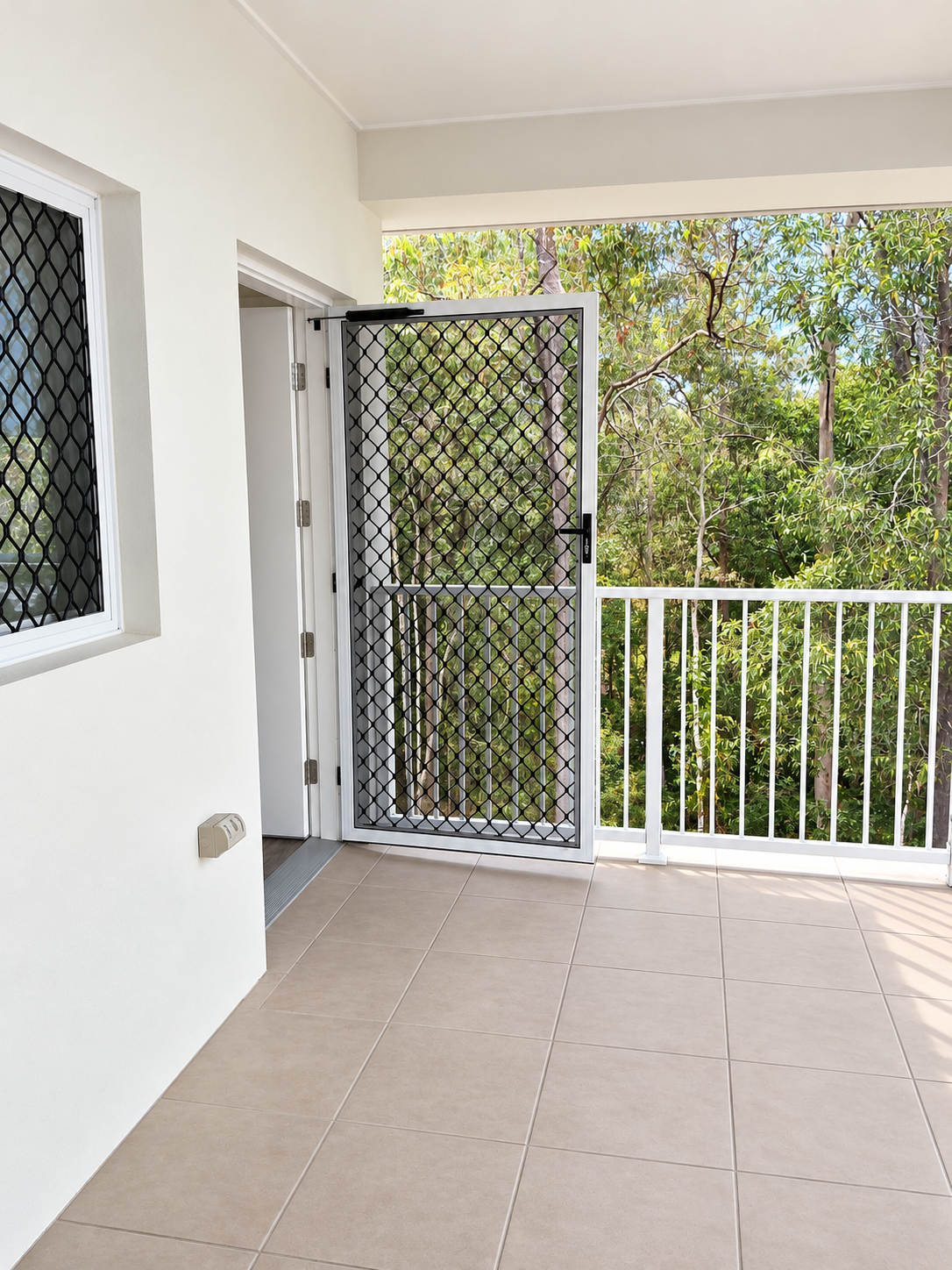 Bright Balcony with Open Security Door.png