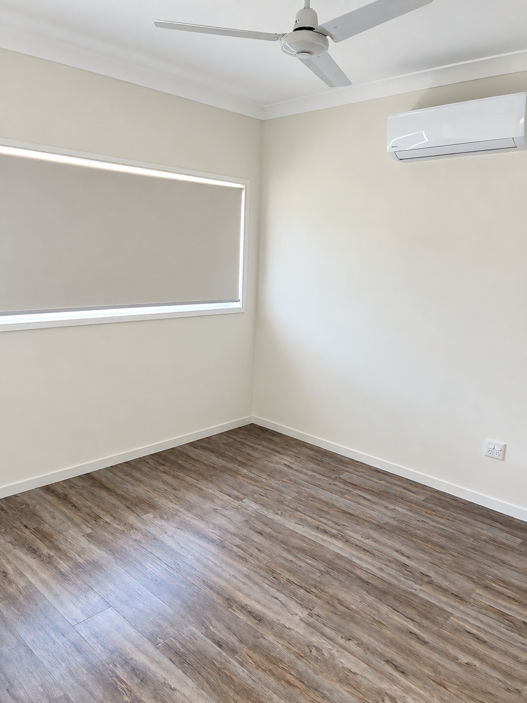 Bright Minimalist Room with Window, Fan, and AC.png