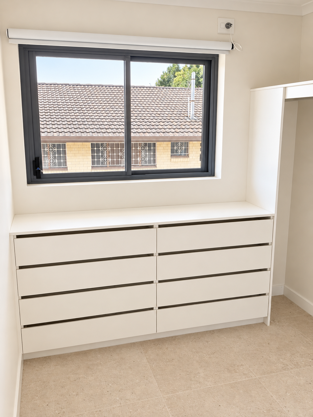Bright Minimalist Bedroom with Built-In Drawers.png