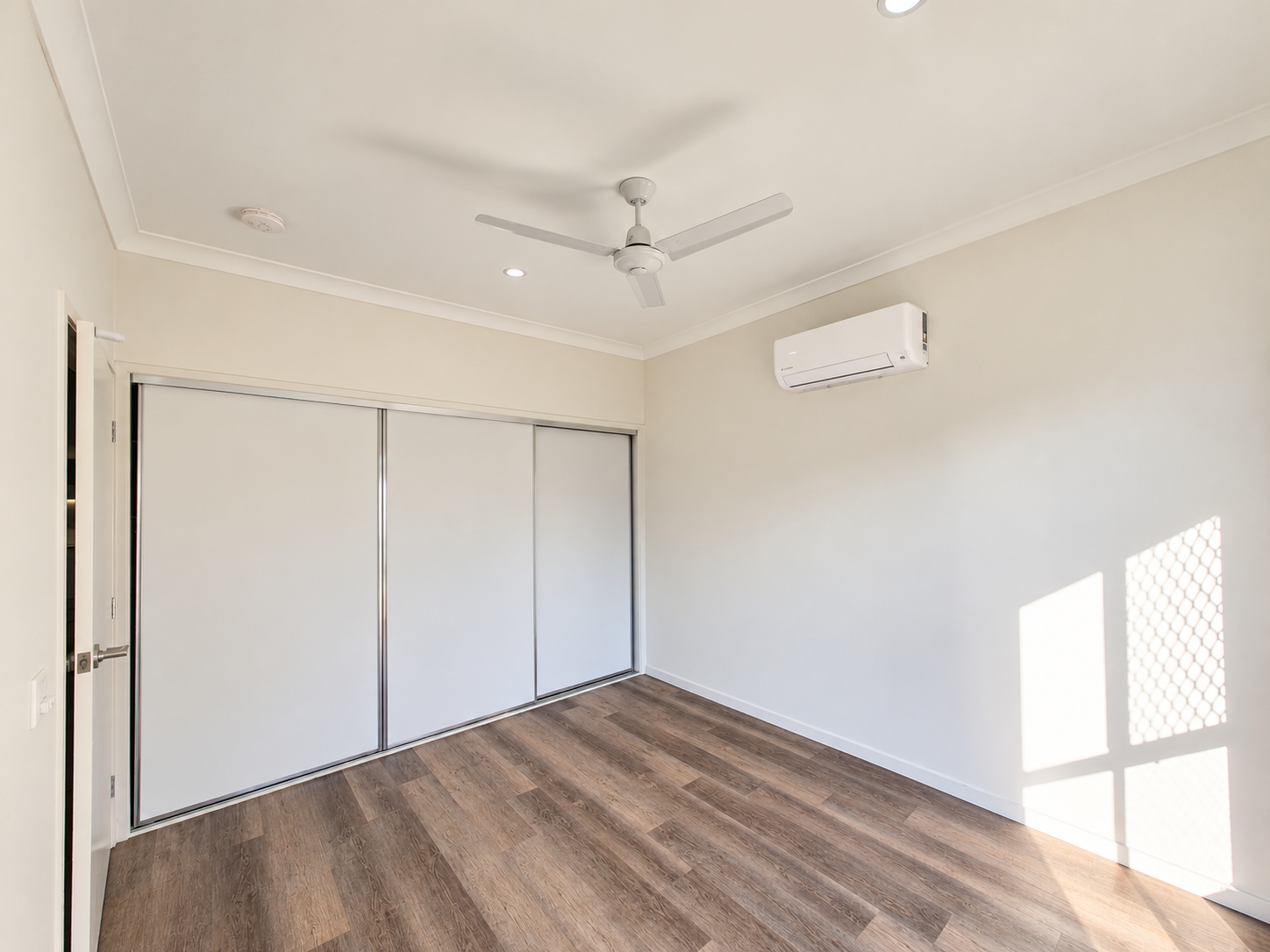 Bright Minimalist Empty Bedroom.png