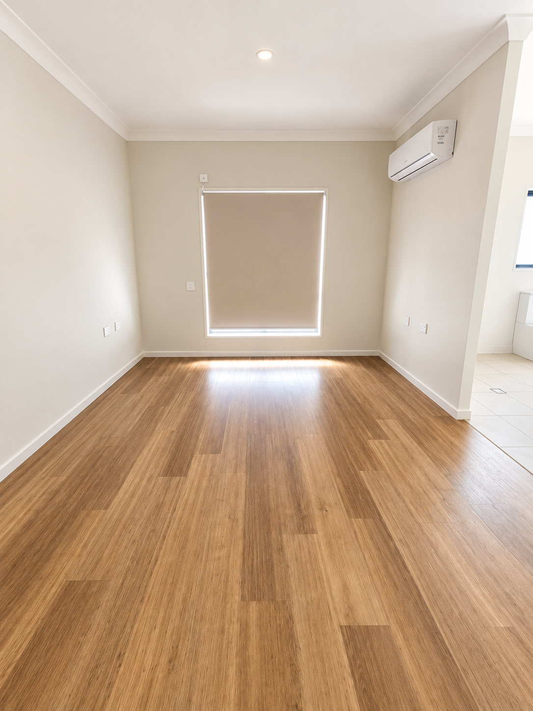 Bright Minimalist Room with Wood Flooring.png