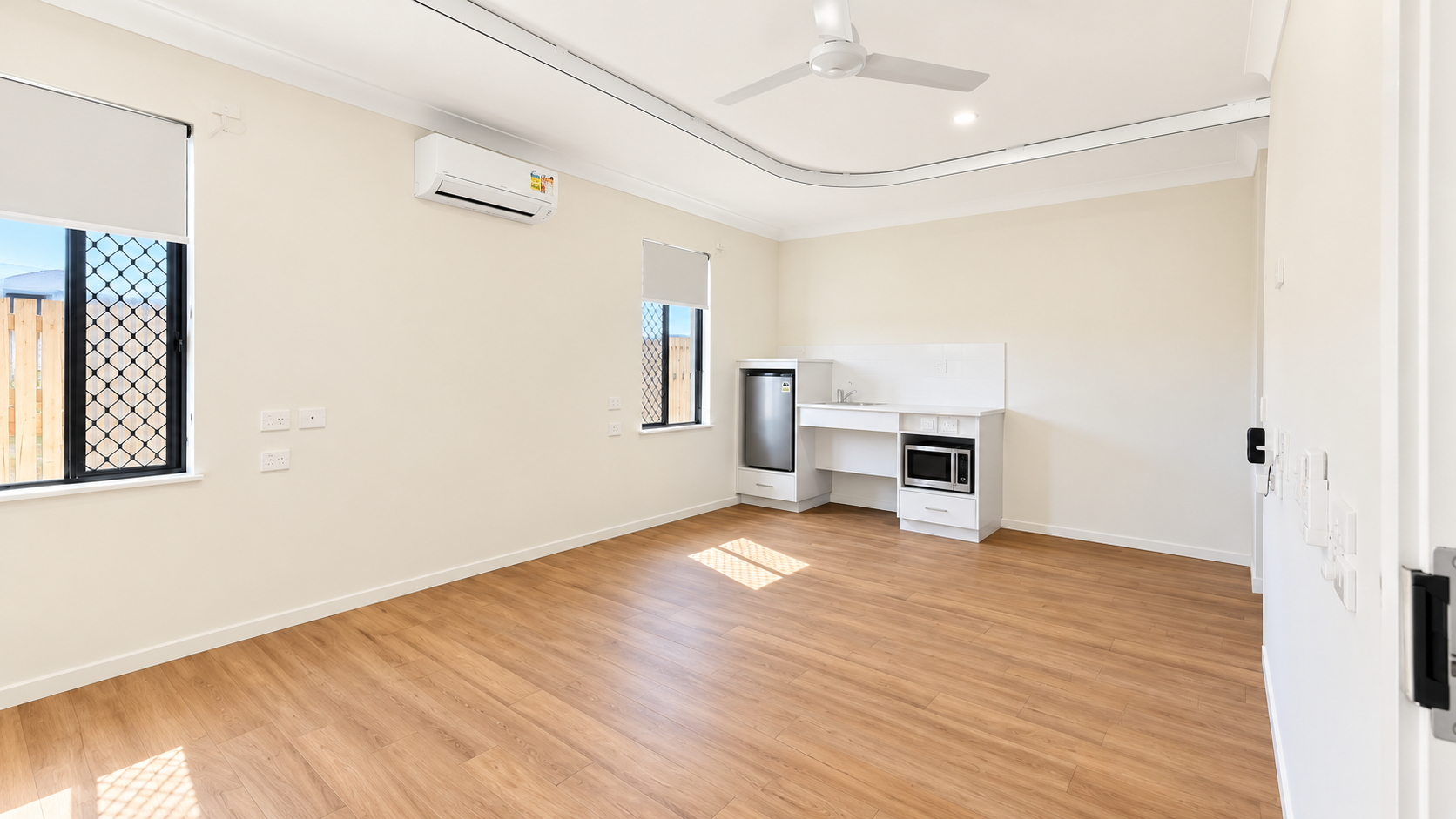 Bright Minimalist Room with Kitchenette.png
