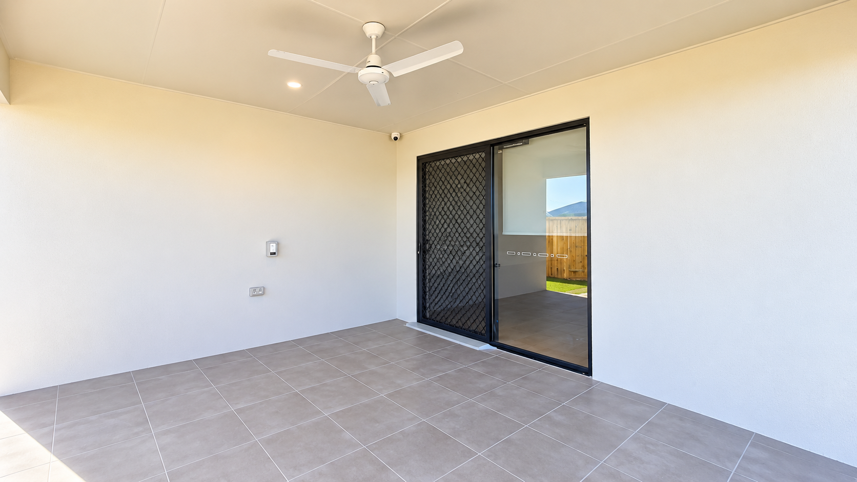 Modern Patio with Sliding Glass Door and Fan.png