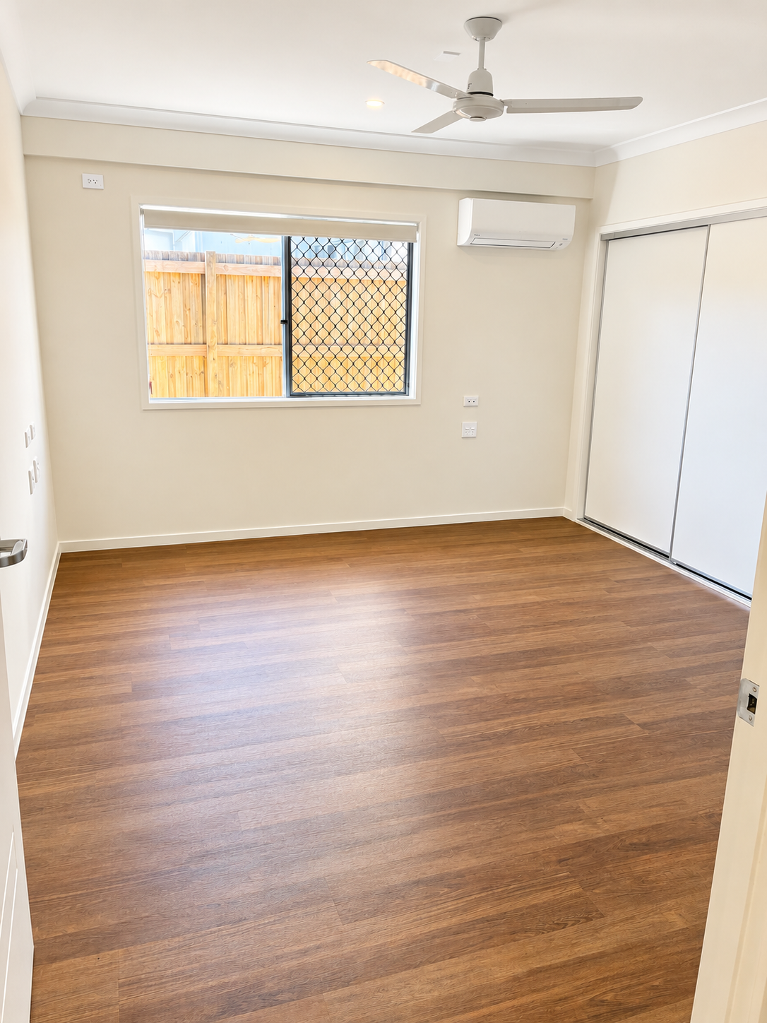 Bright Minimalist Room with Warm Wood Floors.png