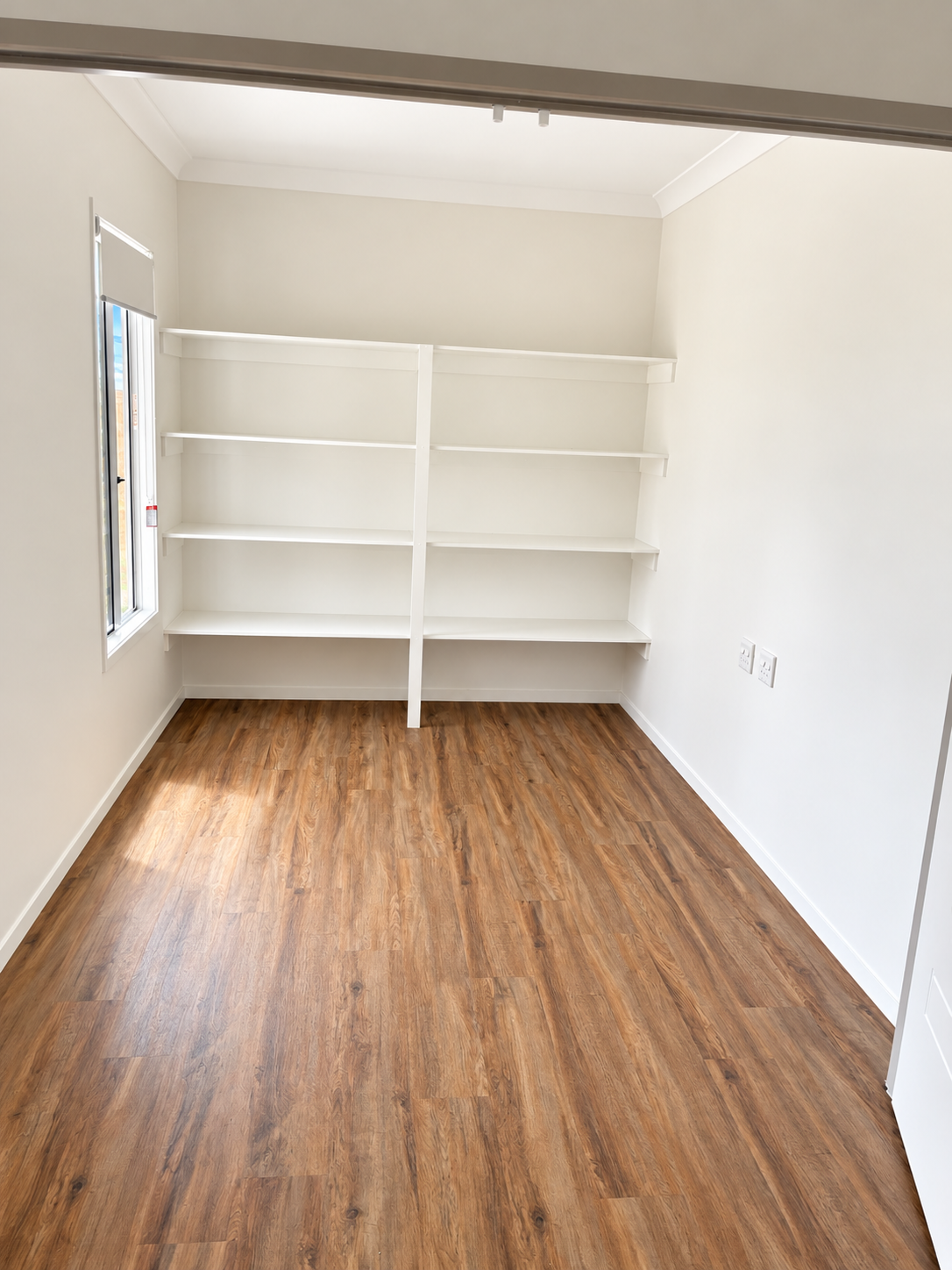 Bright Empty Room with Built-In Shelves.png