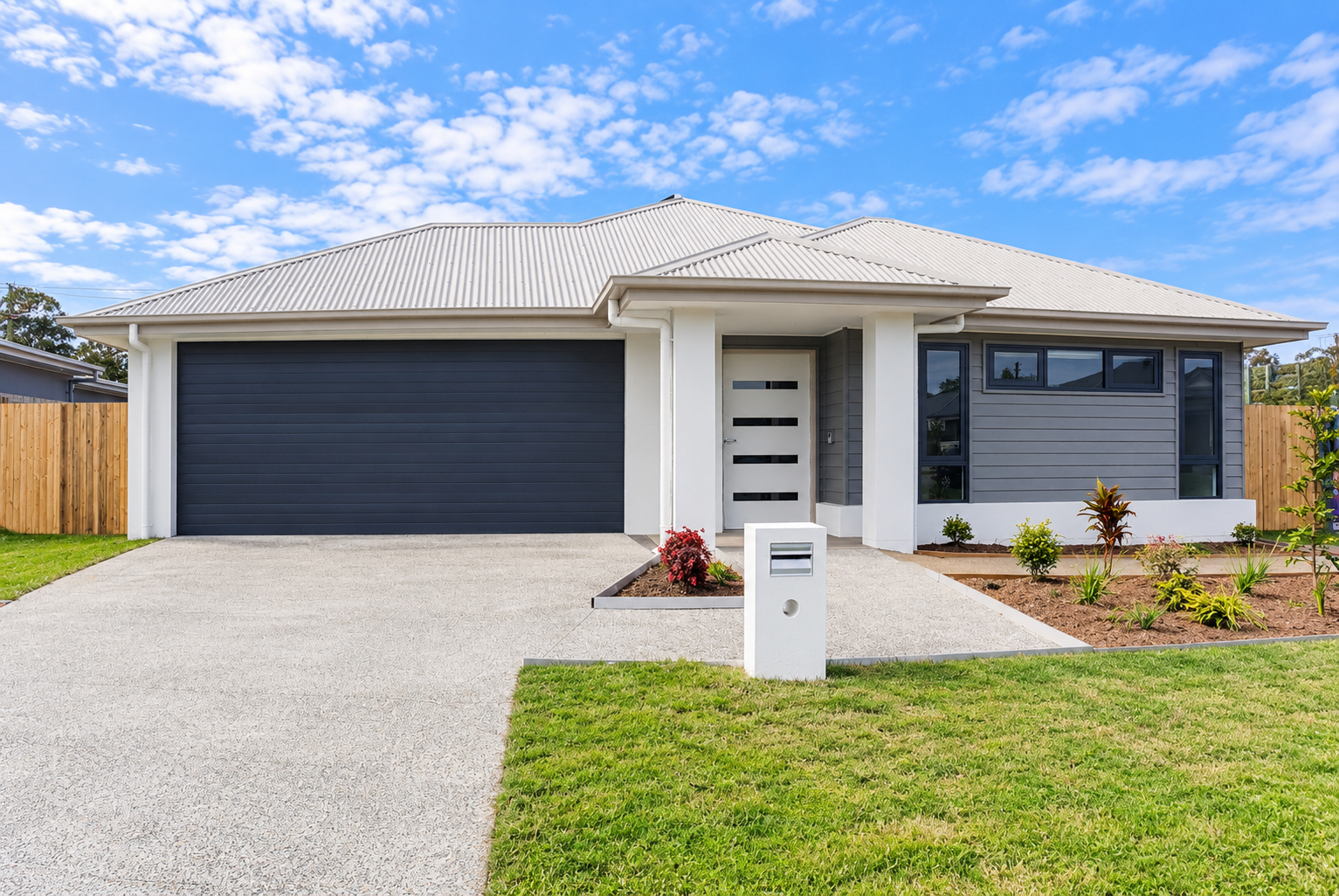 Modern Suburban Home with Landscaped Yard.png