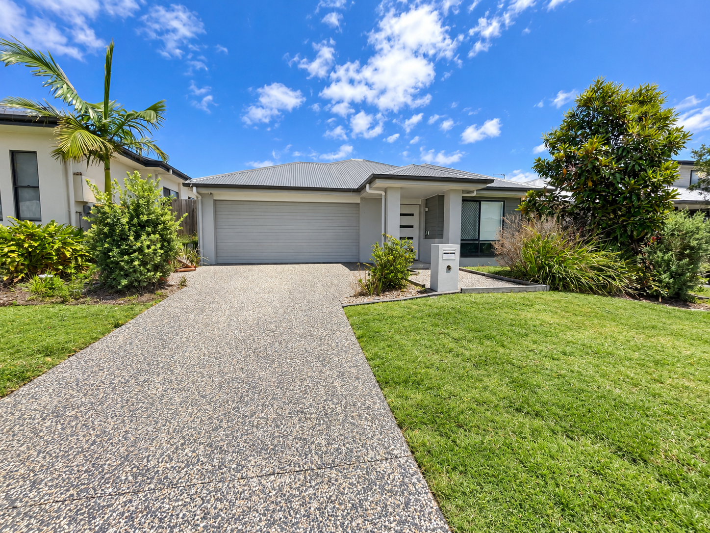 Modern Suburban Home with Landscaped Yard.png
