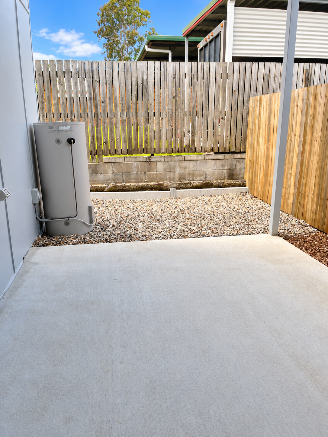 Bright Backyard Patio with Utility Tank.png