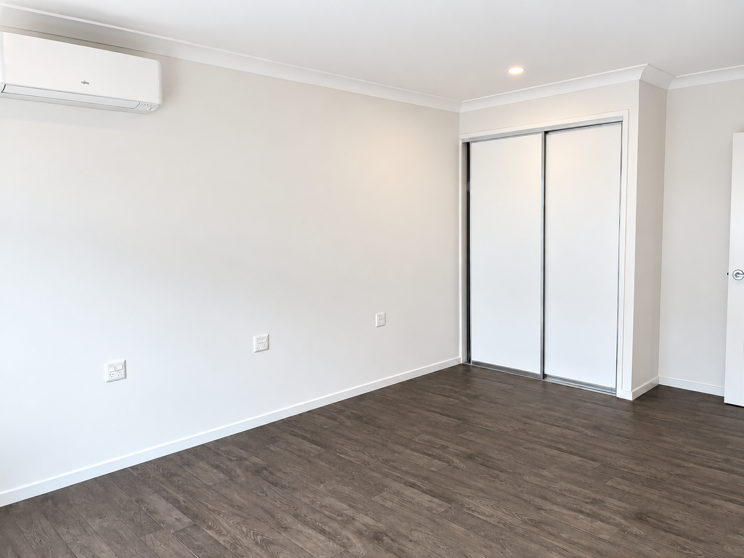 Bright Modern Bedroom with Dark Wood Flooring.png