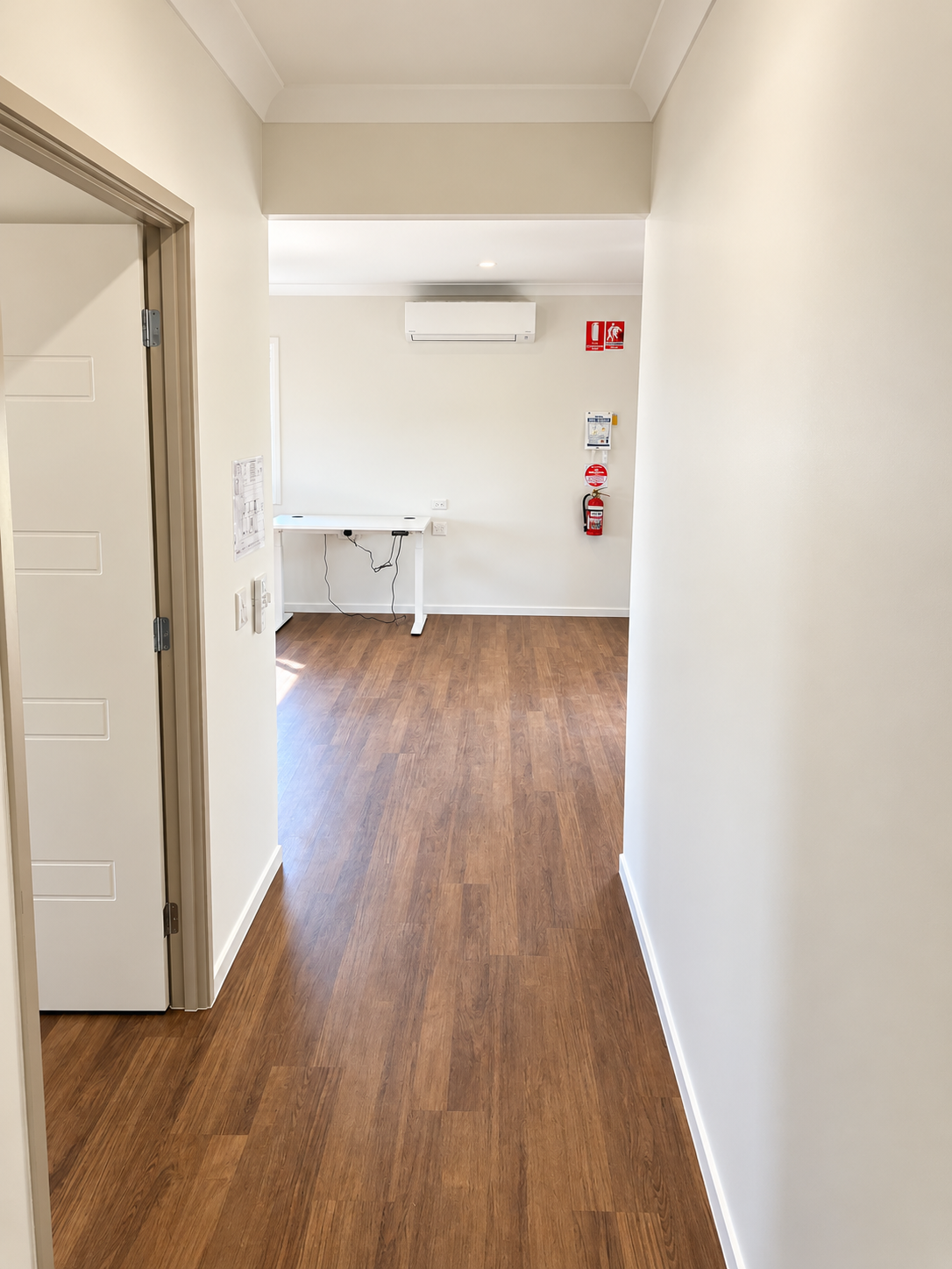 Bright Minimal Hallway with Safety Equipment.png