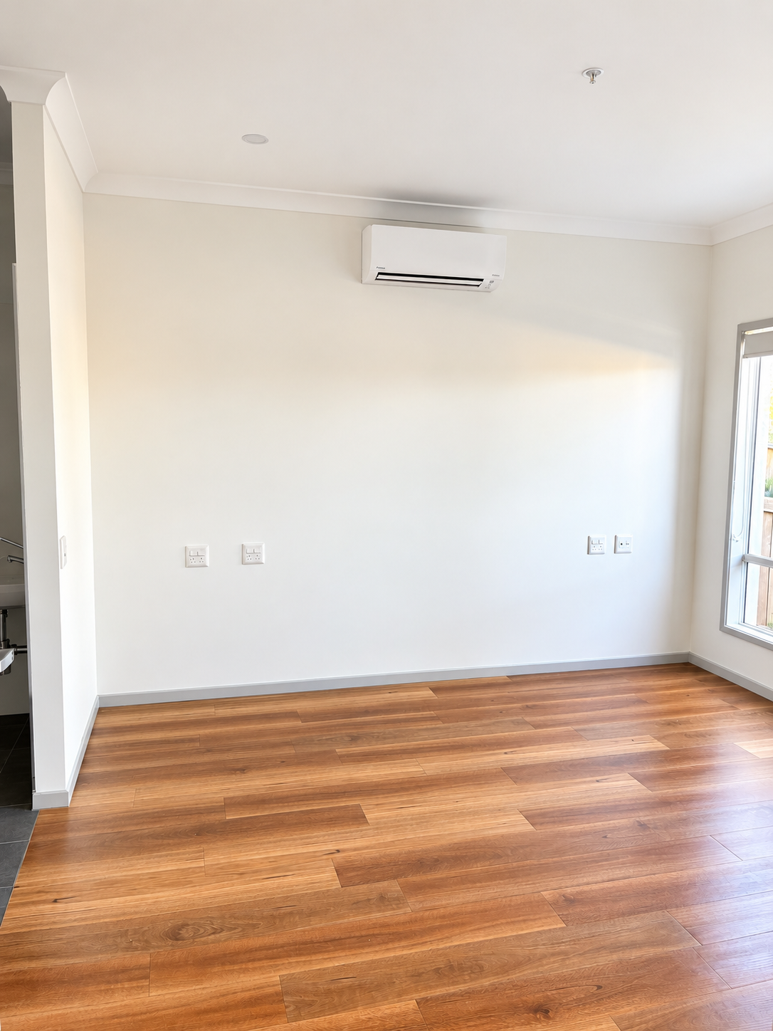 Bright Minimalist Room with Wood Floors.png