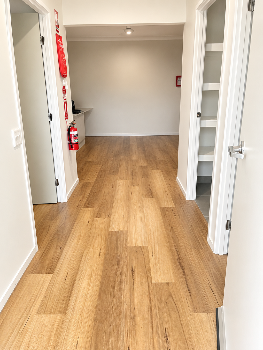Modern Hallway with Fire Safety Equipment.png